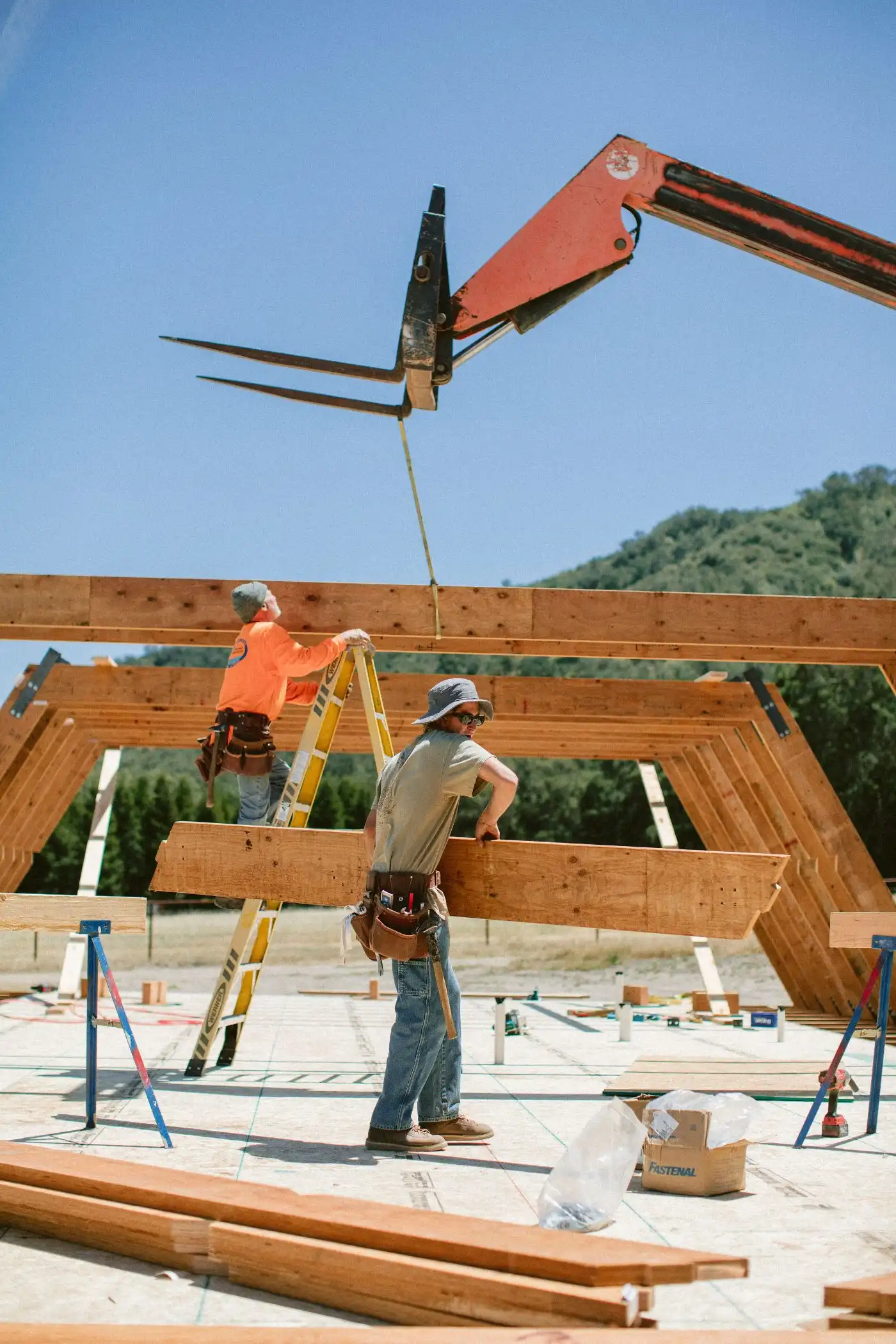 Builders building the structure of an A-frame house