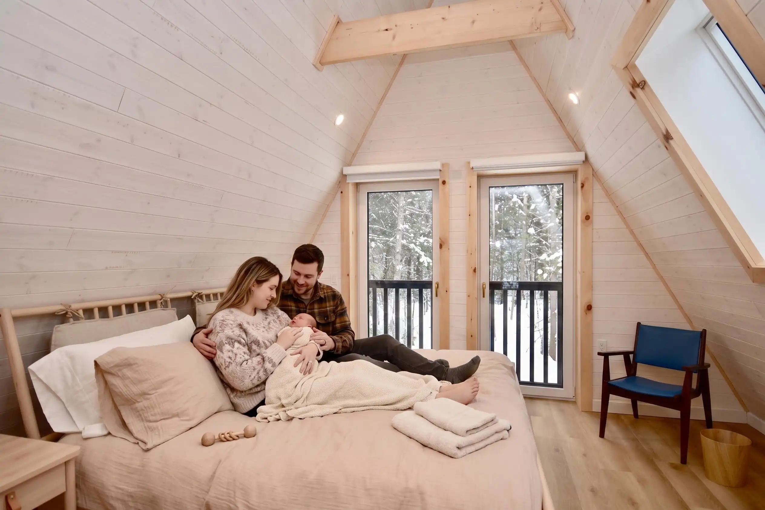 A family with a newborn in a cozy A-frame home