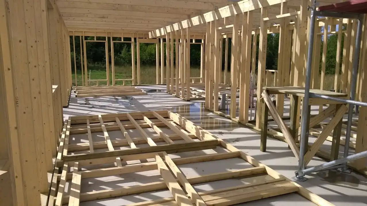 Builders building the structure of an A-frame house